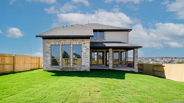 a view of a house with a yard and sitting area