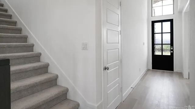 a view of staircase with white walls and windows