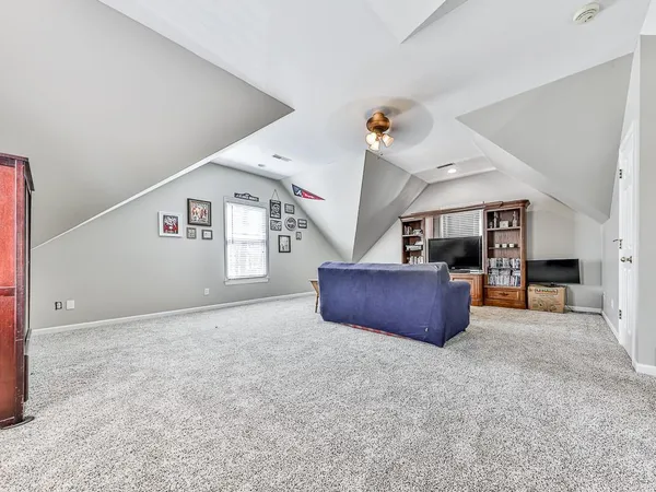 an empty room with closet and windows