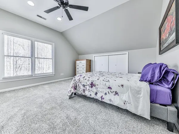 a bedroom with a bed and window