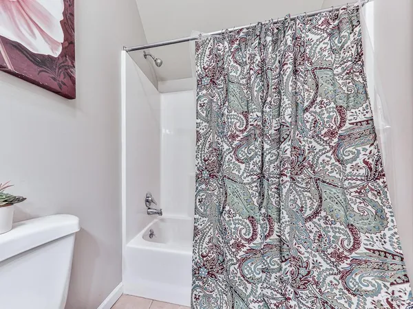 a bathroom with a bathtub and shower