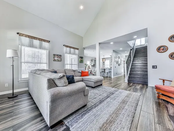 a living room with furniture and wooden floor