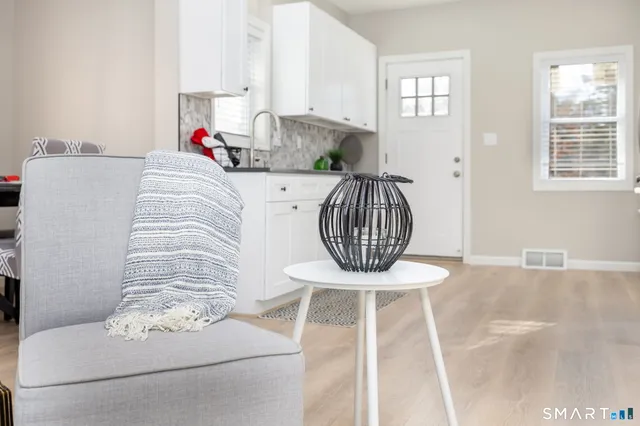an empty room with a window and a fan