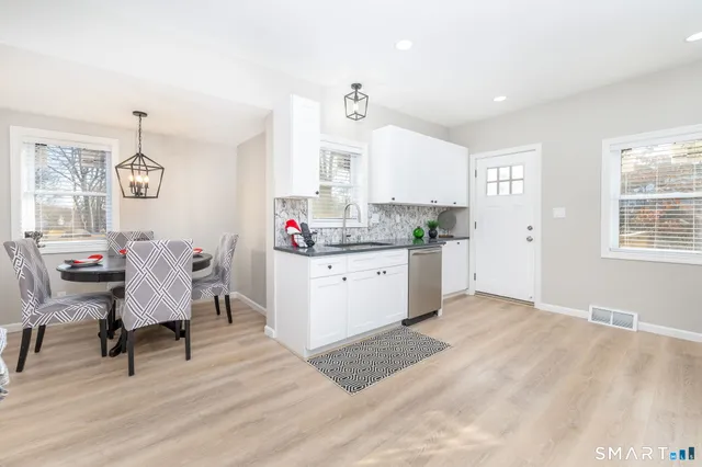 a bedroom with a bed and a potted plant