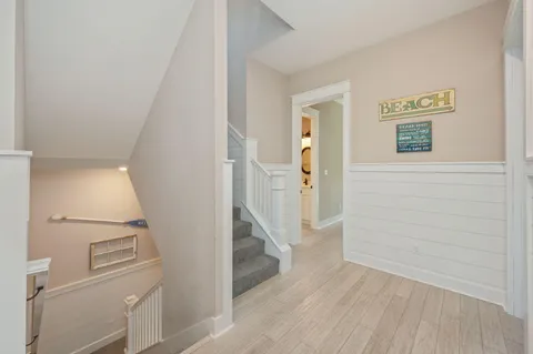 a room with furniture a flat screen tv and a chandelier