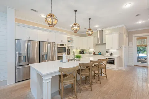 a kitchen with a stove a sink and a refrigerator