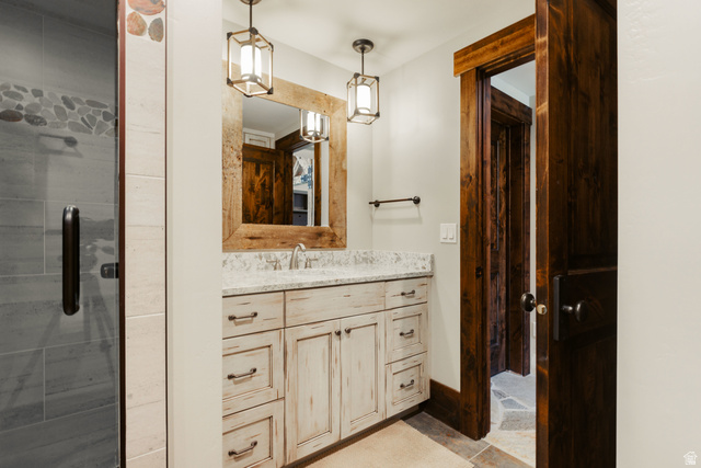1667 West Tollgate Cyn Road Coalville, UT 84017 - Photo 41 of 61 Whitewashed vanity with a light-toned countertop and dual pendant lighting fixtures