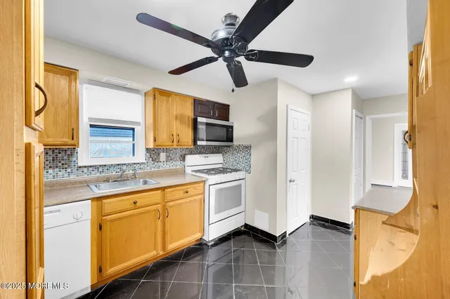 a kitchen with a stove a sink and a refrigerator