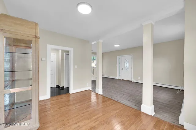 a view of an entryway with wooden floor
