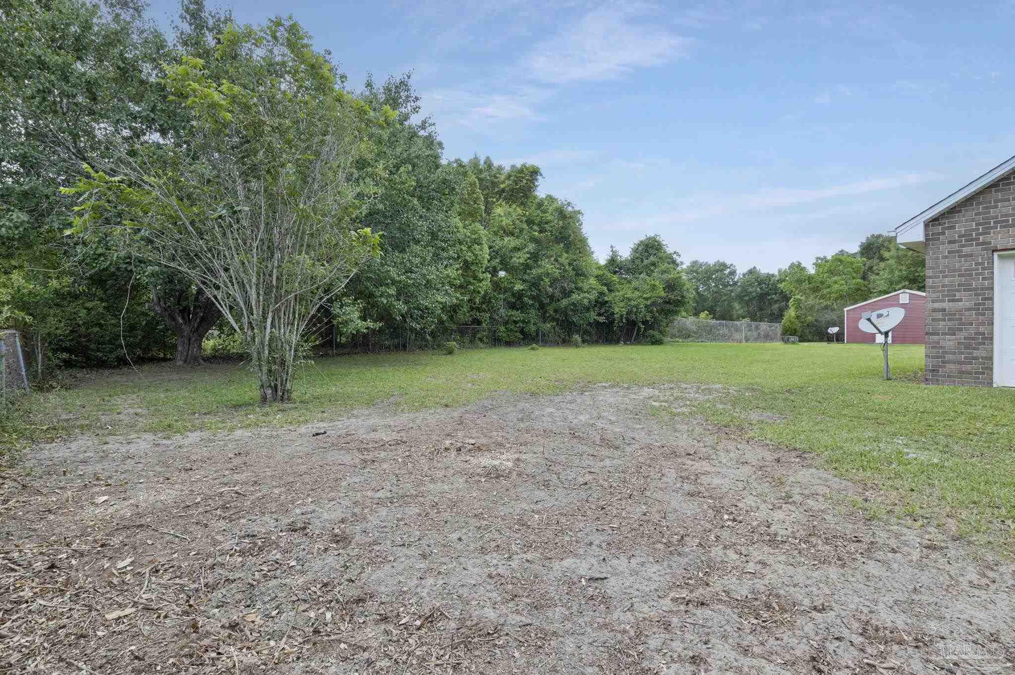 4411 Pace Lane Pace, FL 32571 - Photo 11 of 68 a view of a field with trees in background