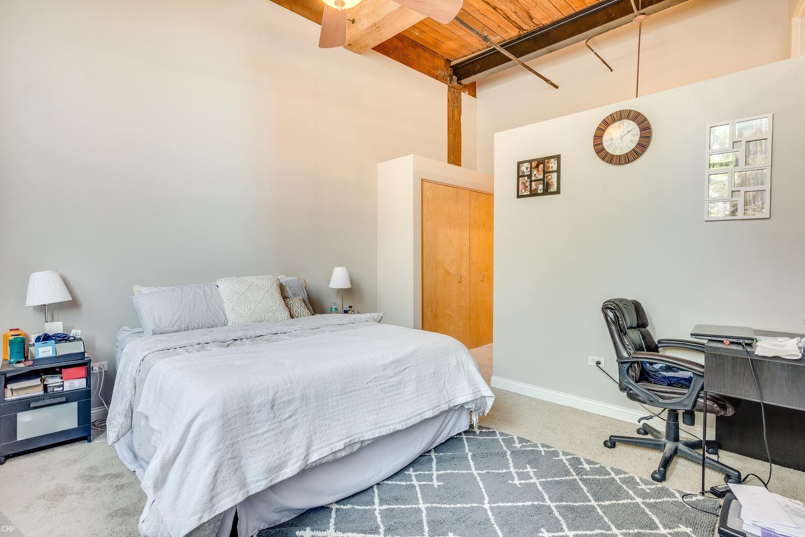 1500 West Monroe Street, Unit 122 Chicago, IL 60607 - Photo 13 of 14 a bedroom with a bed a chair and a table in it