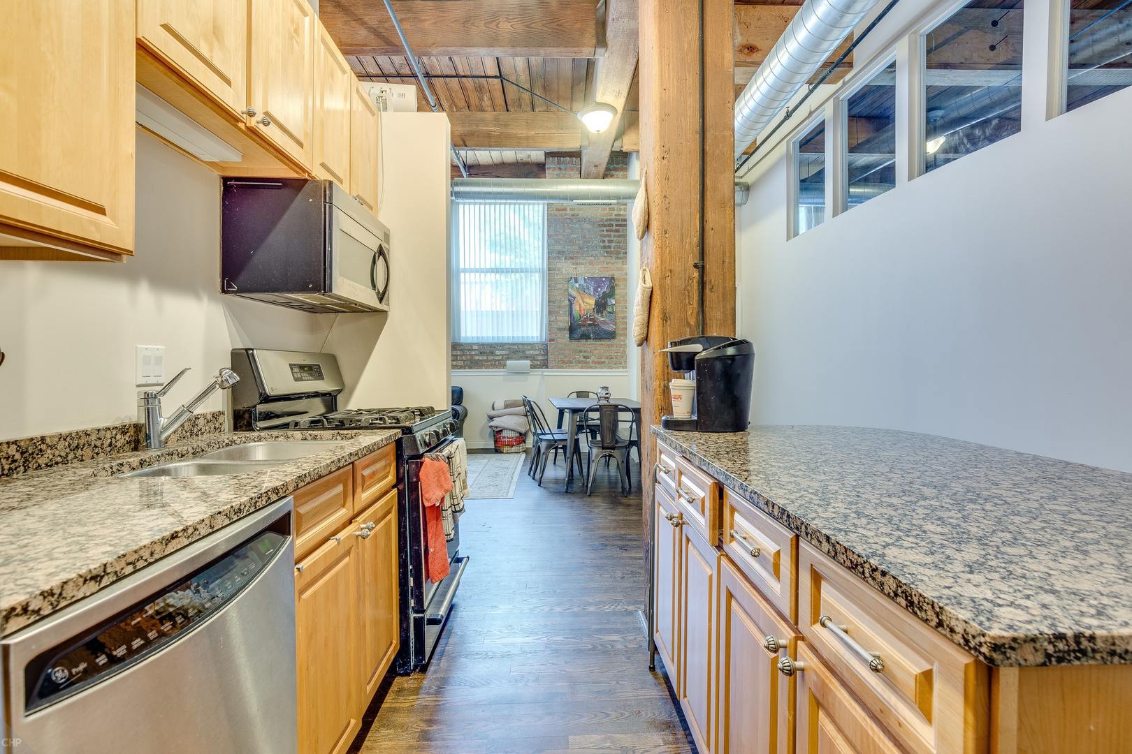 1500 West Monroe Street, Unit 122 Chicago, IL 60607 - Photo 6 of 14 a kitchen with stainless steel appliances granite countertop a stove and a sink