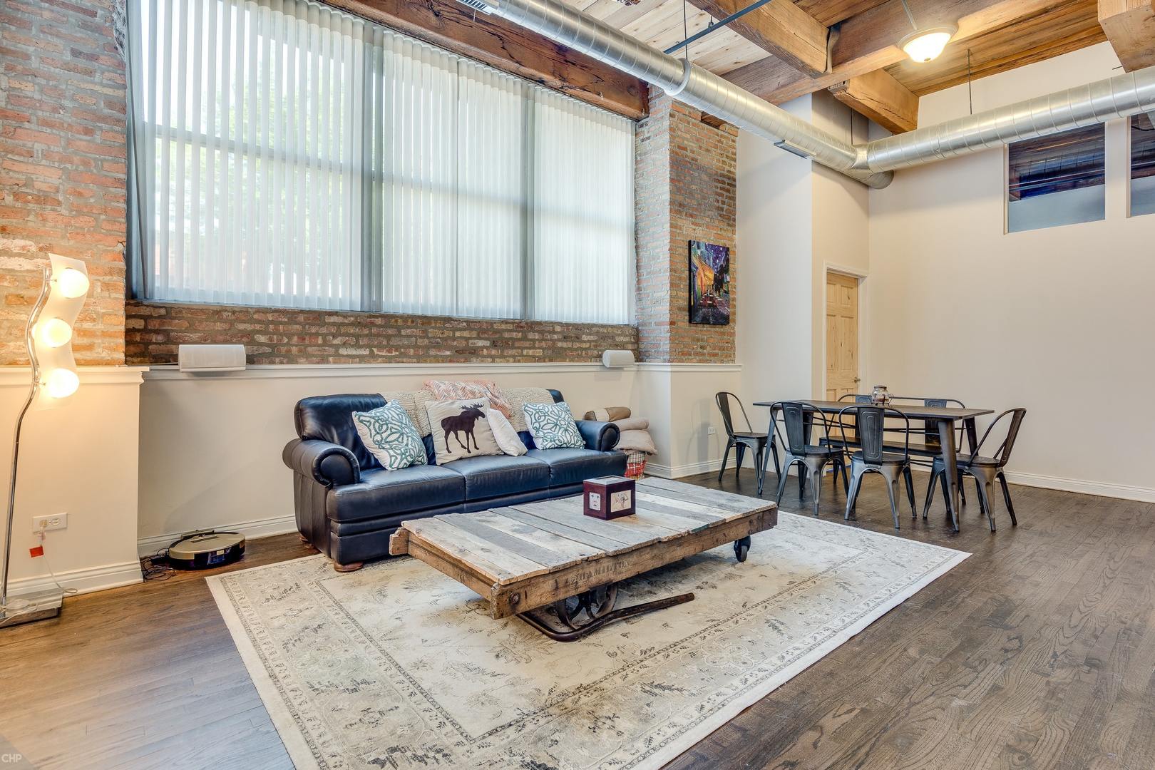 1500 West Monroe Street, Unit 122 Chicago, IL 60607 - Photo 8 of 14 a living room with furniture and a large window