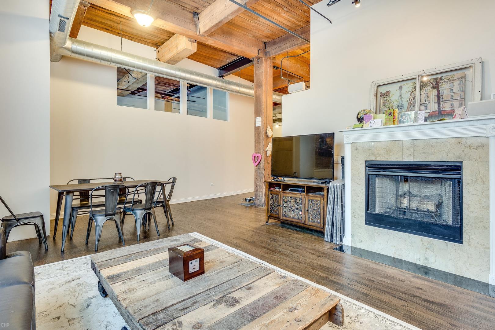 1500 West Monroe Street, Unit 122 Chicago, IL 60607 - Photo 9 of 14 a living room with furniture and a fireplace