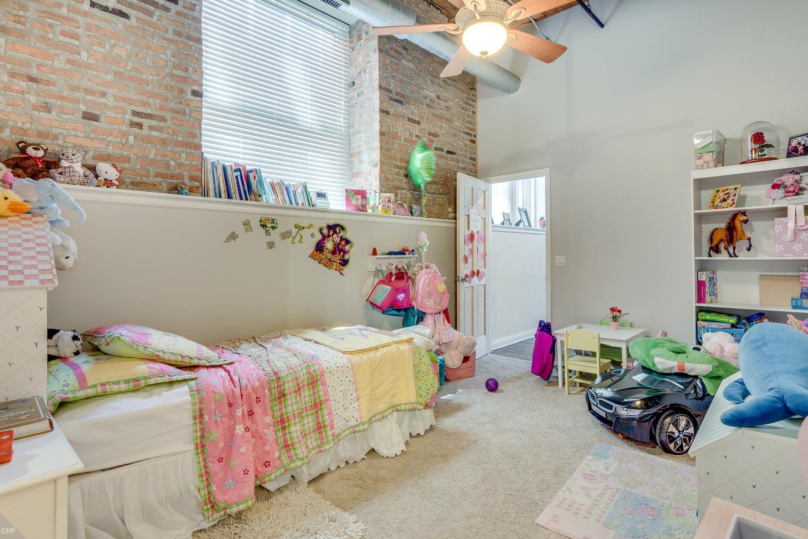 1500 West Monroe Street, Unit 122 Chicago, IL 60607 - Photo 10 of 14 a bedroom with a bed and a chandelier