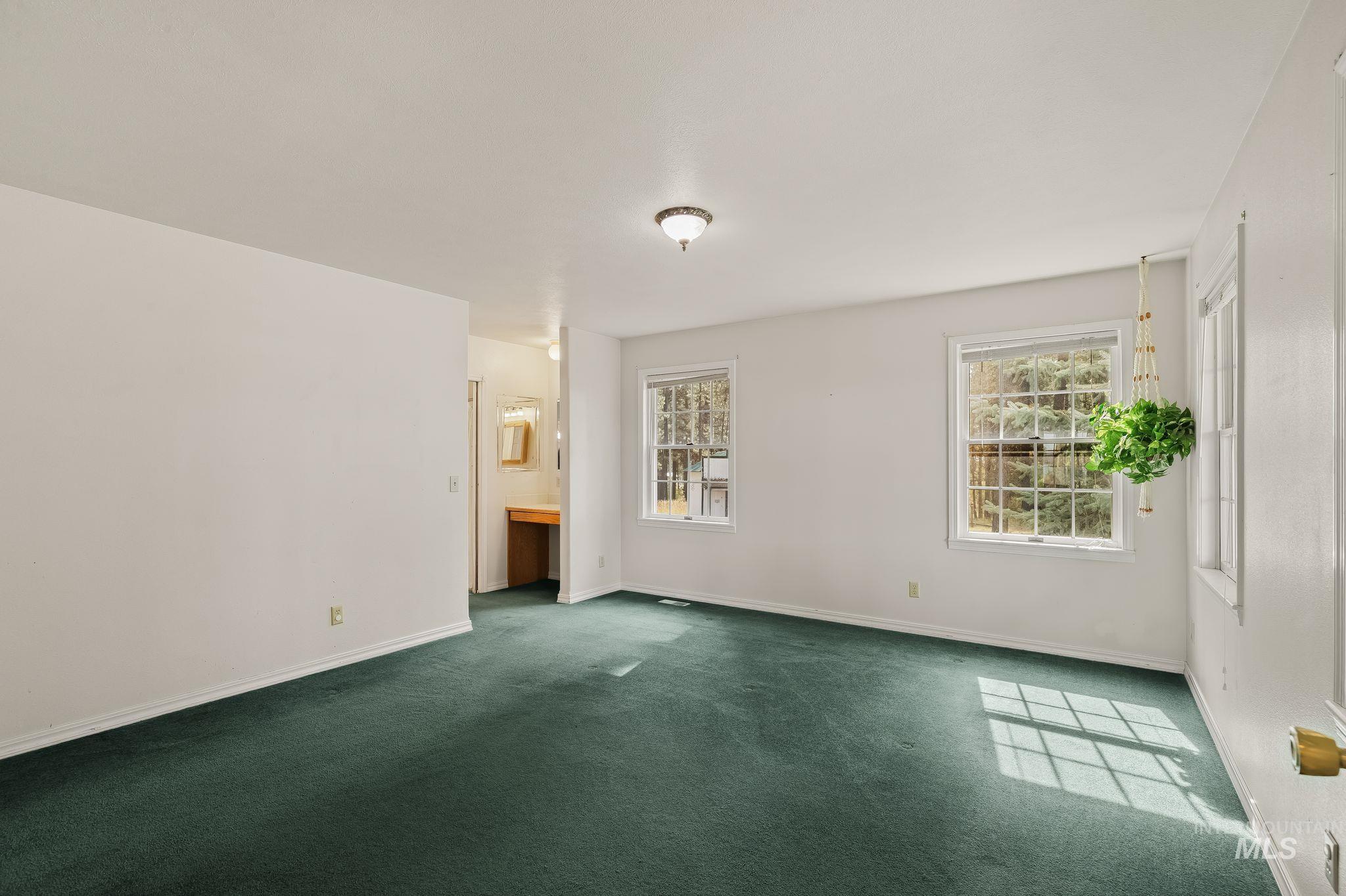 1820 Winchester Road Winchester, ID 83555 - Photo 22 of 50 Expansive room with wall-to-wall carpeting and multiple windows