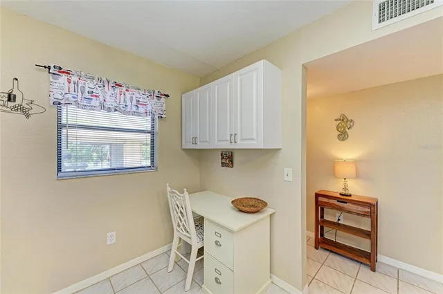 a bedroom with a bed and a large mirror on the dresser