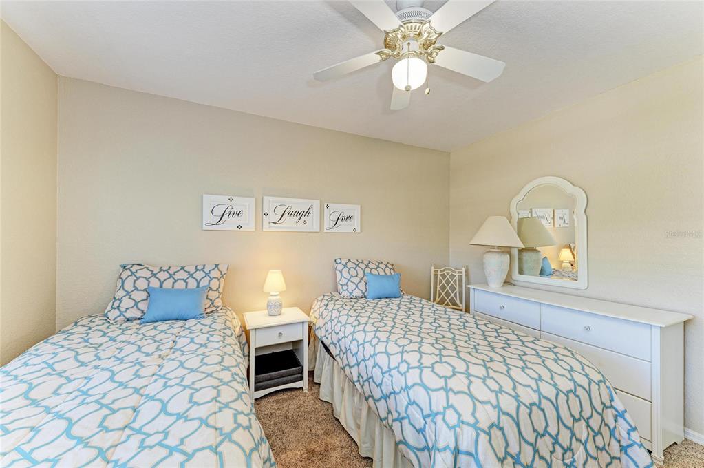 175 Kings Highway, Unit 1114 Punta Gorda, FL 33983 - Photo 29 of 64 a bedroom with a large bed and a chandelier