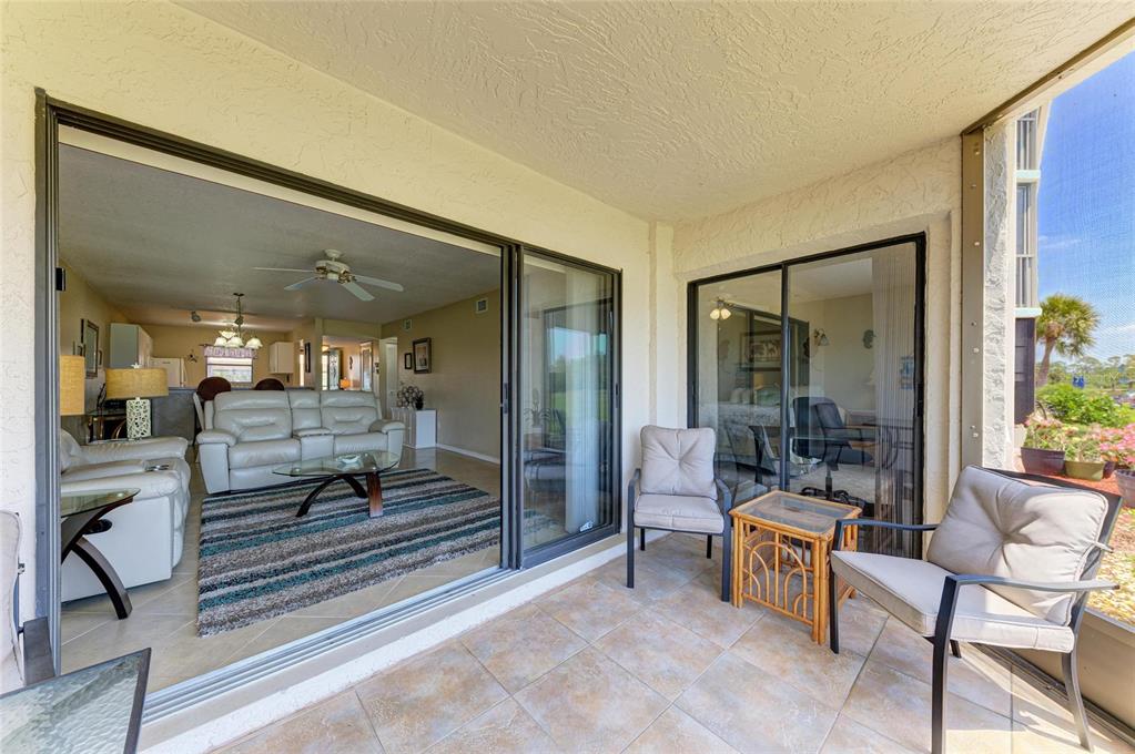 175 Kings Highway, Unit 1114 Punta Gorda, FL 33983 - Photo 34 of 64 a living room with furniture and a painting on the wall