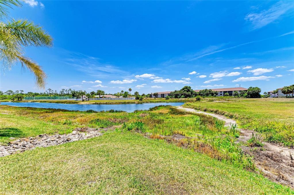 175 Kings Highway, Unit 1114 Punta Gorda, FL 33983 - Photo 55 of 64 a view of an ocean and a yard