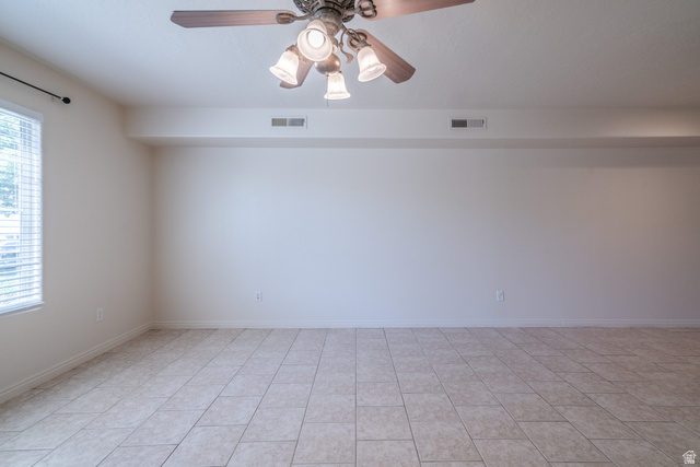 1735 West 540 North, Unit 1805 St. George, UT 84770 - Photo 14 of 64 Spacious room featuring neutral-toned tile flooring, a window with horizontal blinds, and a multi-light ceiling fan with decorative housing