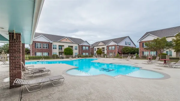 a front view of residential houses with yard and swimming pool