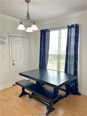 a room with furniture pool table and windows