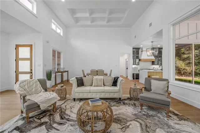 a kitchen with kitchen island a large counter top space appliances and a chandelier