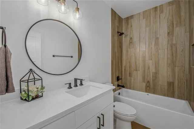 a large bathroom with a sink mirror and a bathtub