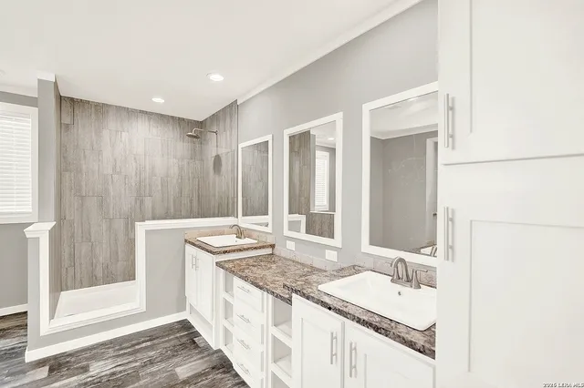 a spacious bathroom with a granite countertop sink and a bathtub