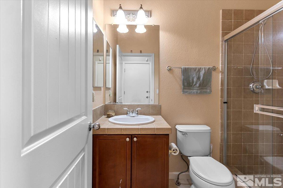 2540 Perryville Drive Reno, NV 89521 - Photo 23 of 27 a bathroom with a sink a toilet and shower