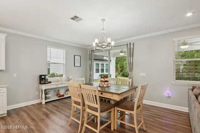 a spacious bedroom with a bed and a chandelier