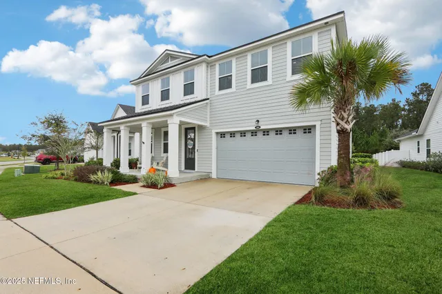 a view of a dining room with furniture wooden floor and a chandelier