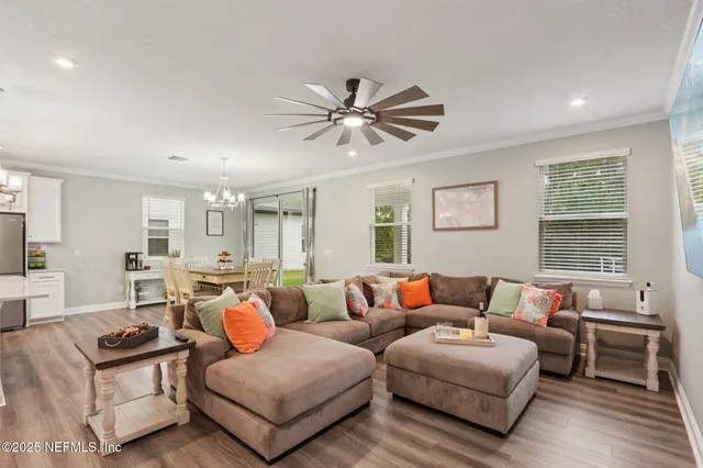 a kitchen with a sink a counter top space and living room view