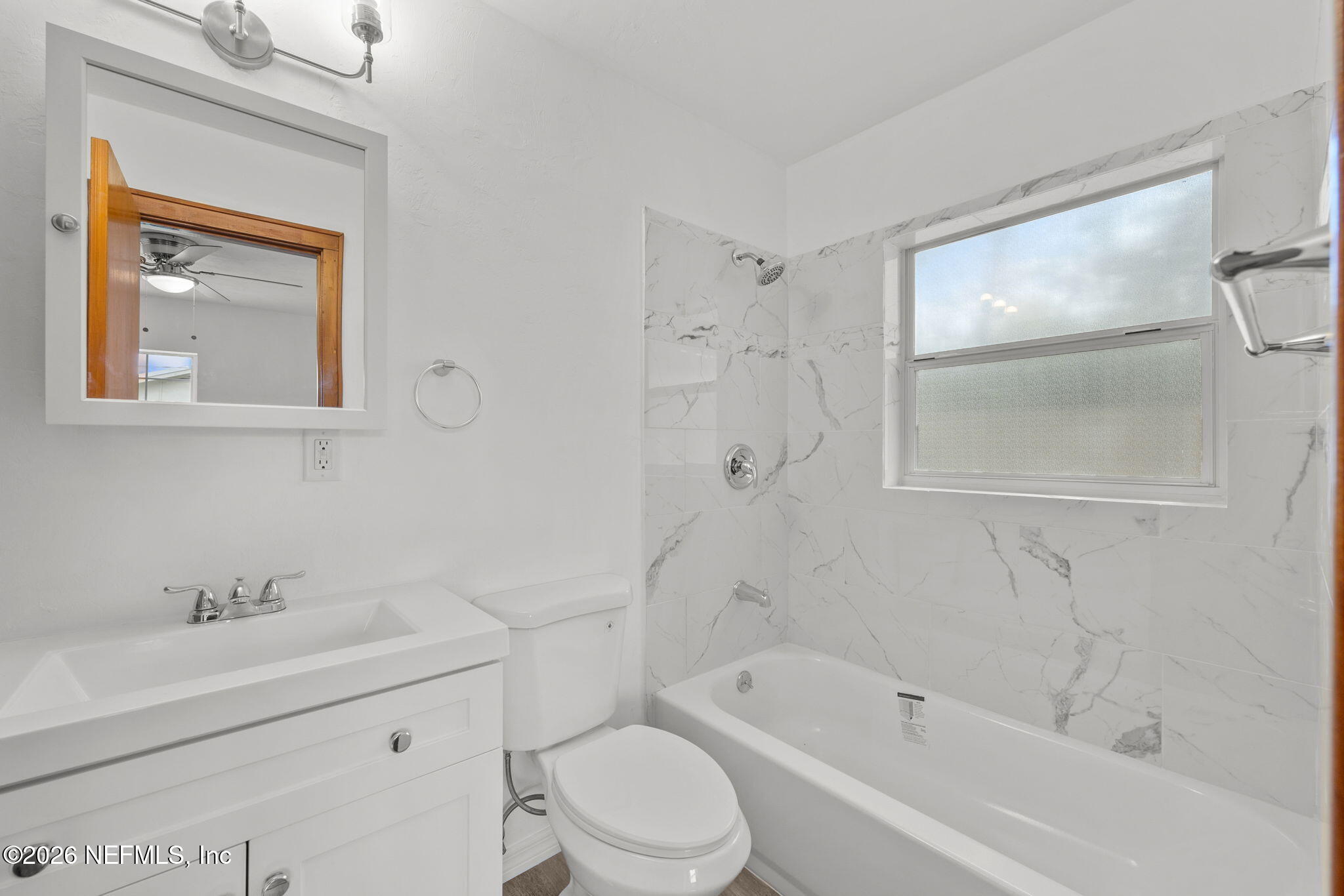 2003 Laurel Street Palatka, FL 32177 - Photo 24 of 31 a bathroom with a bathtub toilet sink vanity and mirror