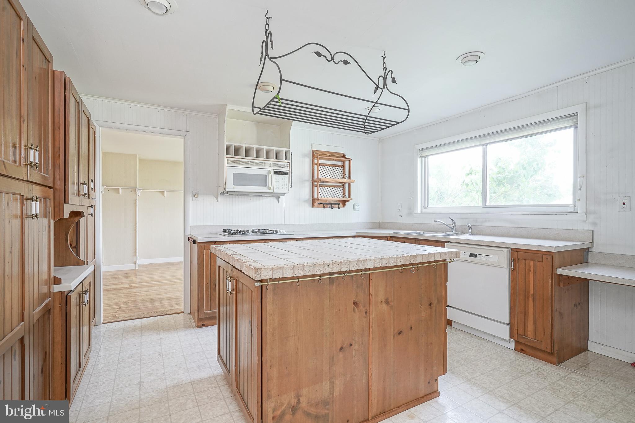 152 Kelly Driver Road Laurel Springs, NJ 08021 - Photo 9 of 30 a kitchen with a stove a sink a refrigerator and window