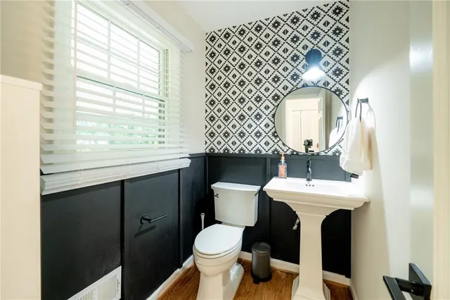 a bathroom with a sink mirror vanity and toilet
