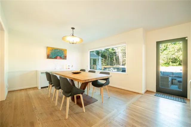 a dining room with a wooden table and chairs