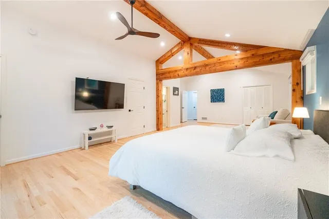 a bedroom with a bed and a flat screen tv