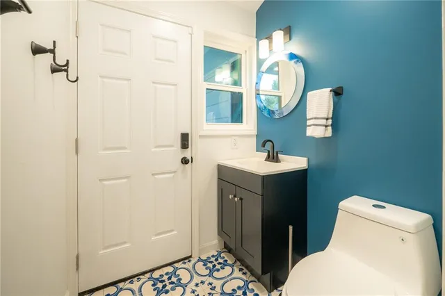 a bathroom with a toilet sink and mirror