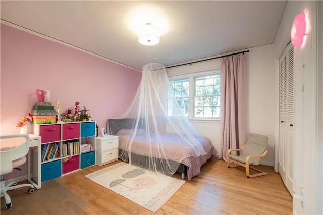 a bedroom with bunk bed and a window