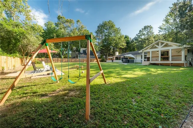 a view of a house with a backyard