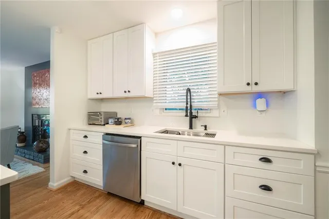 a kitchen with white cabinets and white appliances