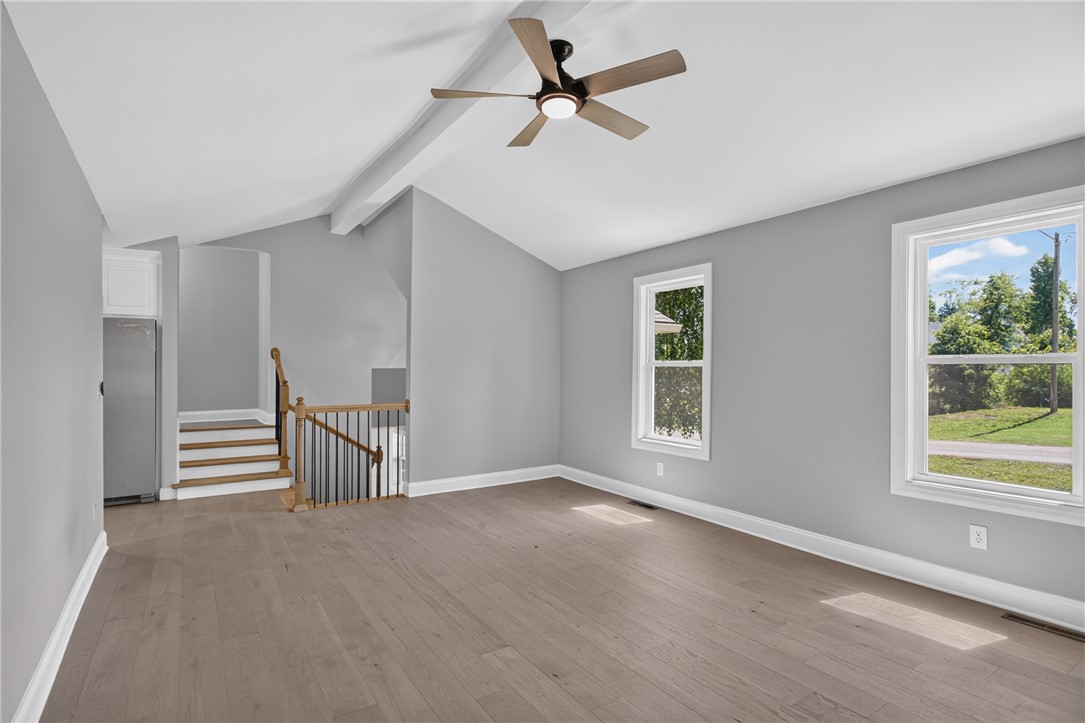 712 Beech Drive Seneca, SC 29678 - Photo 12 of 41 A vibrant living space with a ceiling fan, abundant natural light, and easy stair access.