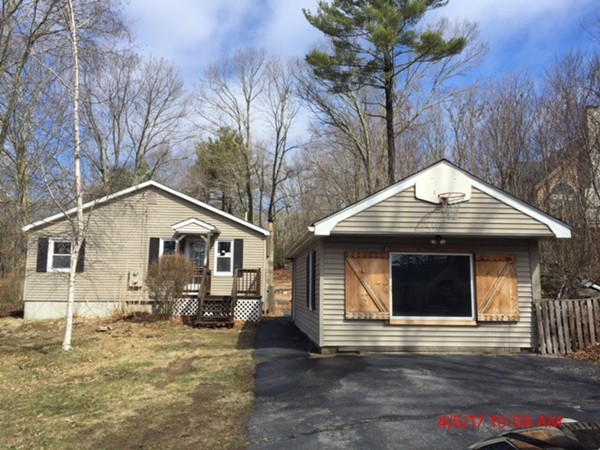 103 Gore Road Webster, MA 01570 - Photo 1 of 24 a front view of a house with a yard and garage