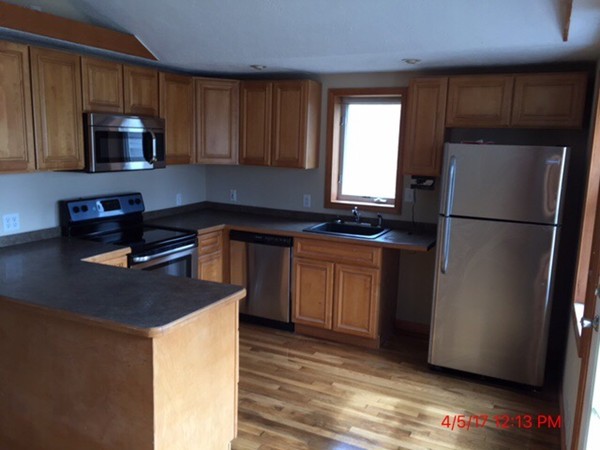 103 Gore Road Webster, MA 01570 - Photo 2 of 24 a kitchen with a refrigerator stove and microwave