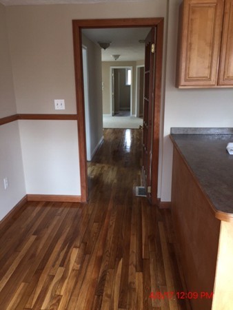 103 Gore Road Webster, MA 01570 - Photo 6 of 24 a view of a hallway with wooden floor and staircase