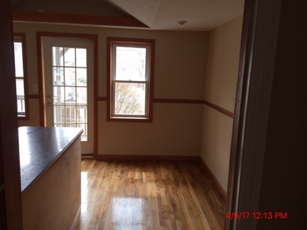 103 Gore Road Webster, MA 01570 - Photo 7 of 24 an empty room with wooden floor and windows