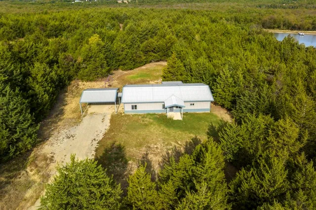 a view of a house with yard and sitting area