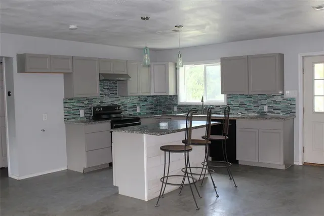 a view of a yard with a tree